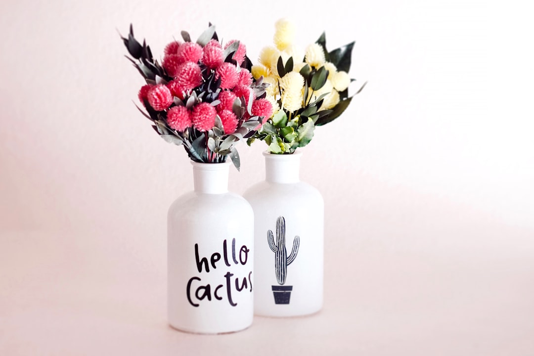 assorted flowers in white ceramic vases