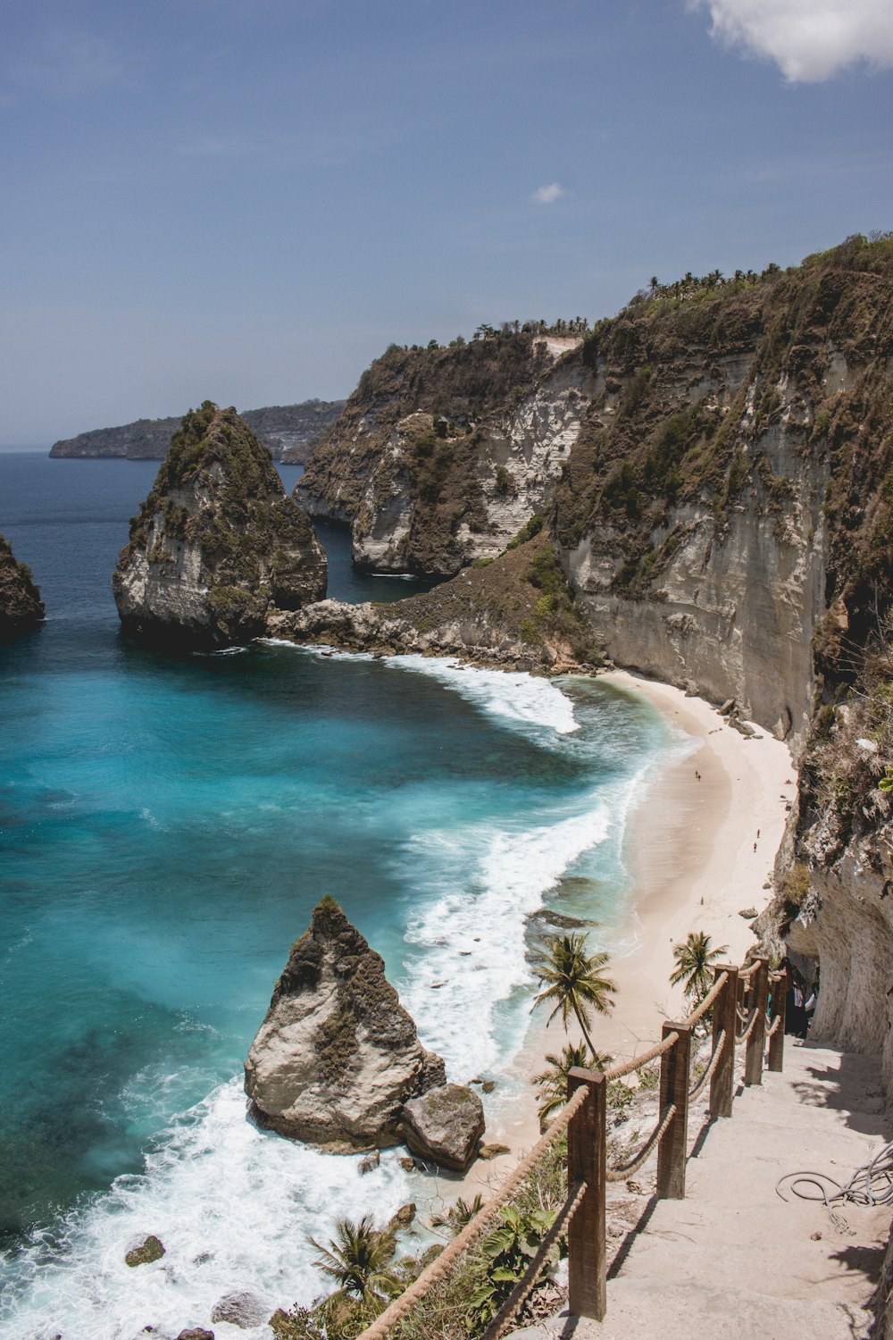 body of water beside rock formation