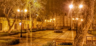A quiet plaza at dusk, with warm lights glowing from surrounding cafes.