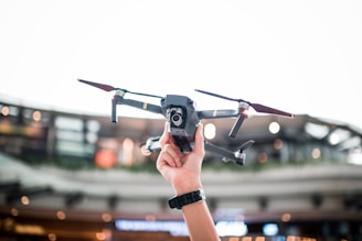 person holding DJI drone for aerial photography and real estate property inspections