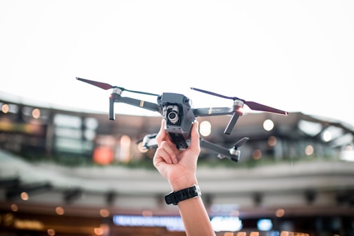 person holding DJI drone for aerial photography and real estate property inspections