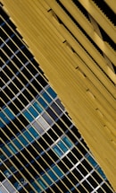 A sleek geometric pattern in slate and gold hues symbolizing connection and communication.