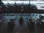 Close-up of a mixing console with colorful lights glowing in a dim studio.