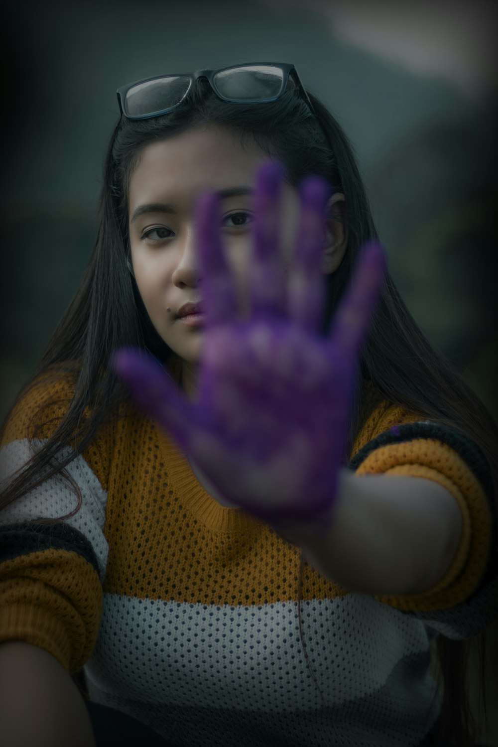 woman showing her left hand with purple paint