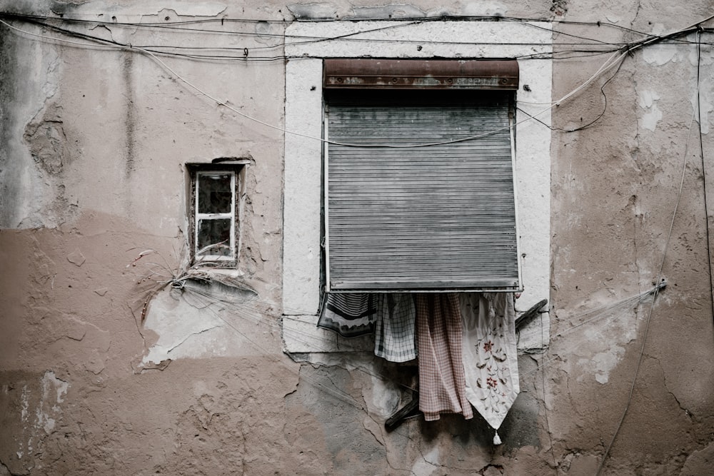 brown concrete building wth closed window