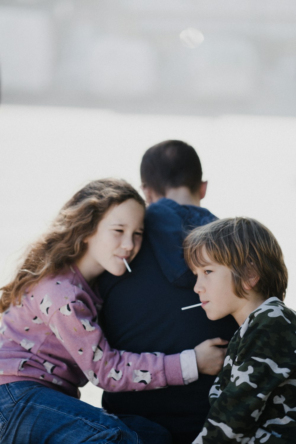 girl and boy eating lollipop