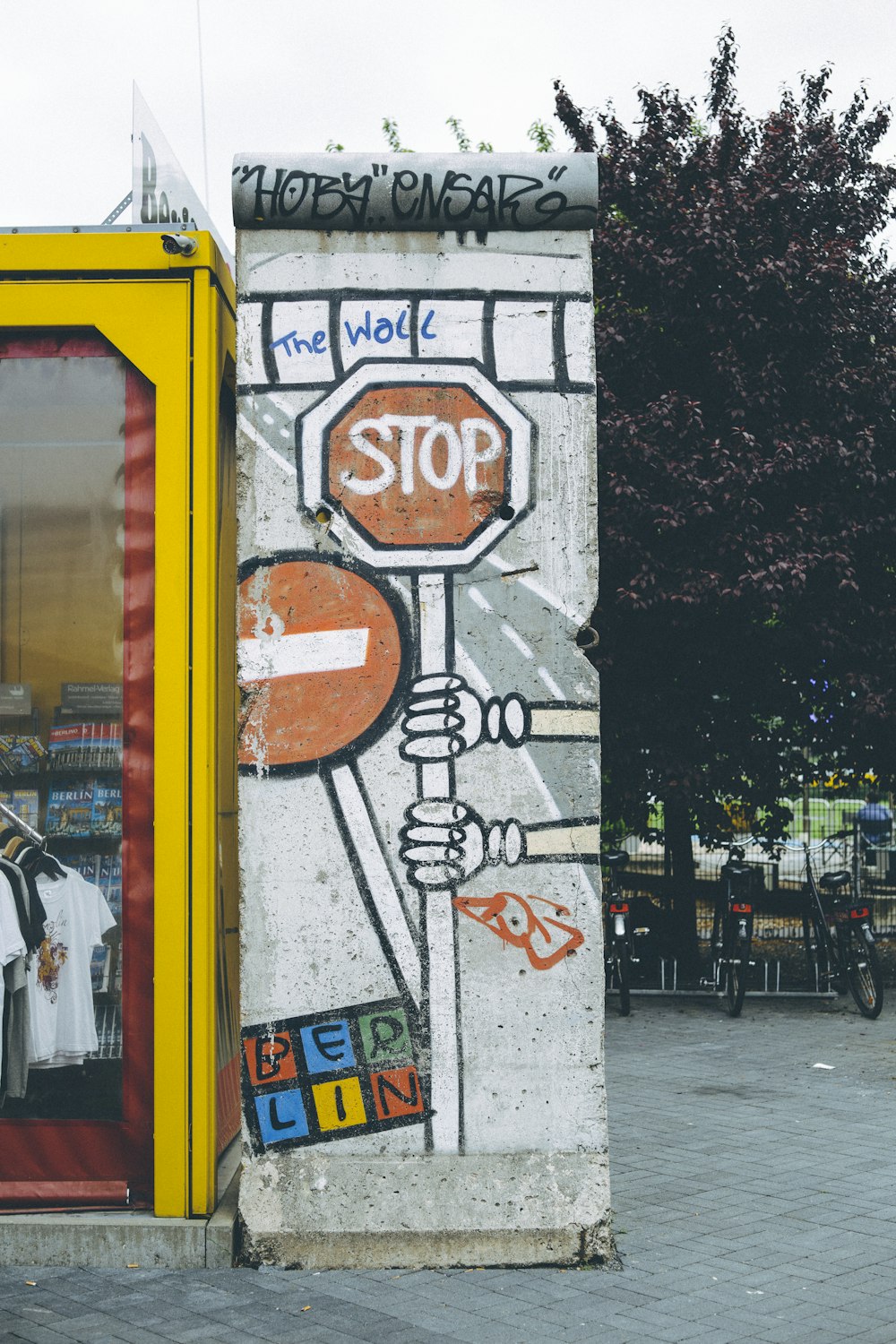 person holding Stop sign graffiti