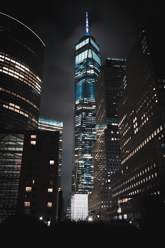 One World Trade Center building during night timne in Rockefeller Park United States