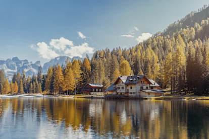 white and brown house near body of water during daytime