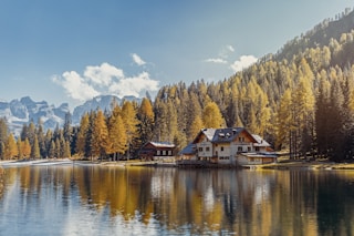 white and brown house near body of water during daytime