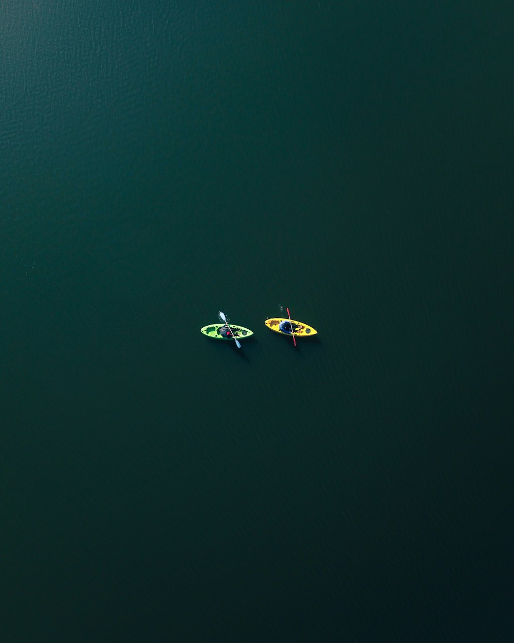 two people riding on two kayaks