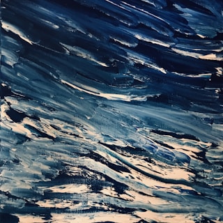 Close-up of textured brushstrokes depicting crashing waves with vibrant blues and whites.