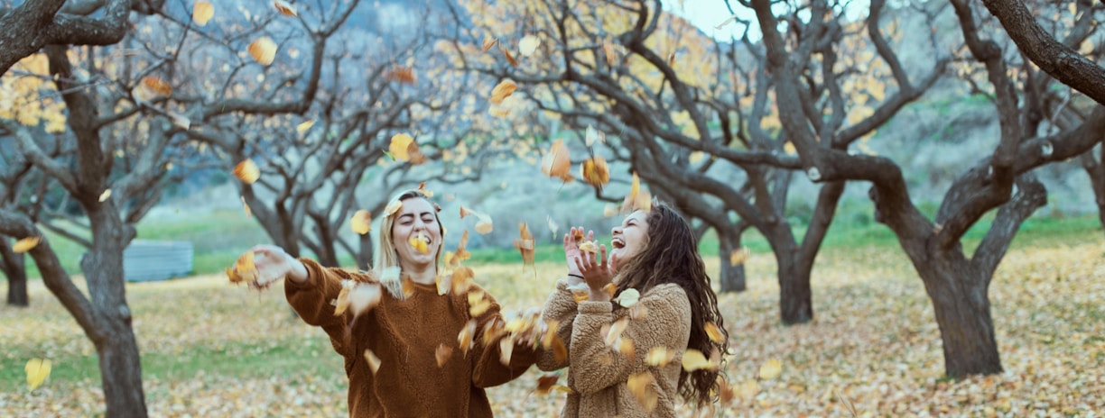 two smiling women in woods