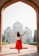 woman with hands on air facing mosque