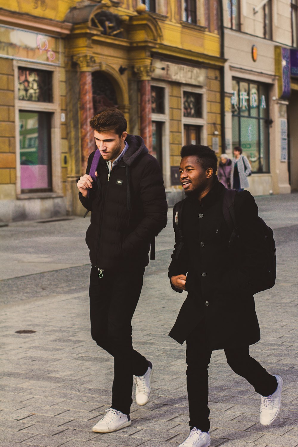 two men walking on street during daytime