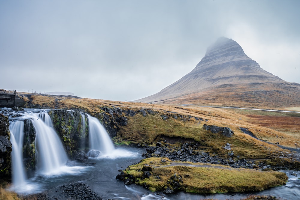 waterfalls near mountains during daytime