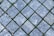 Interlocking stone pavers arranged in a diagonal grid pattern with patches of green moss filling the spaces between the stones.
