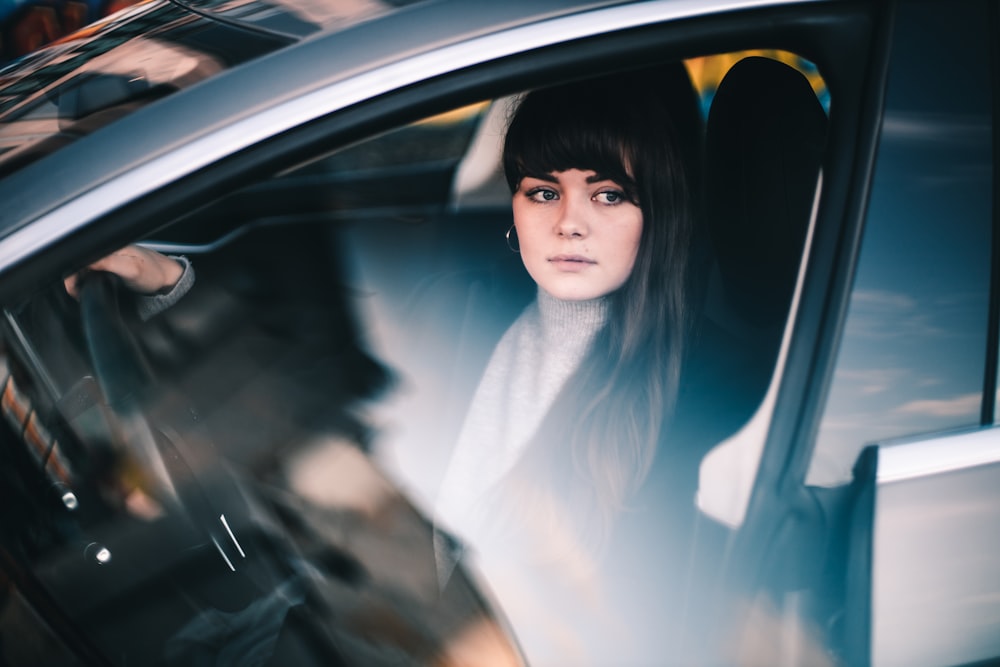woman sitting inside vehicle