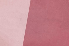 a close up of a pink and white background