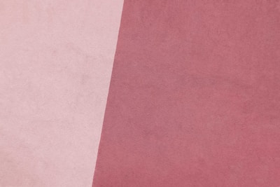 a close up of a pink and white background