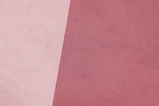 a close up of a pink and white background