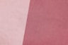 a close up of a pink and white background