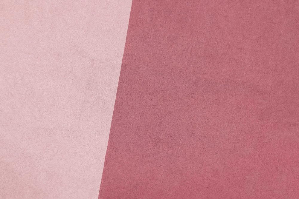 a close up of a pink and white background