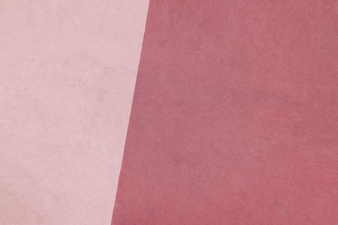 a close up of a pink and white background