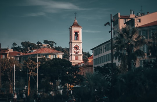 landscape photography of white and red tower clock in Place Masséna France