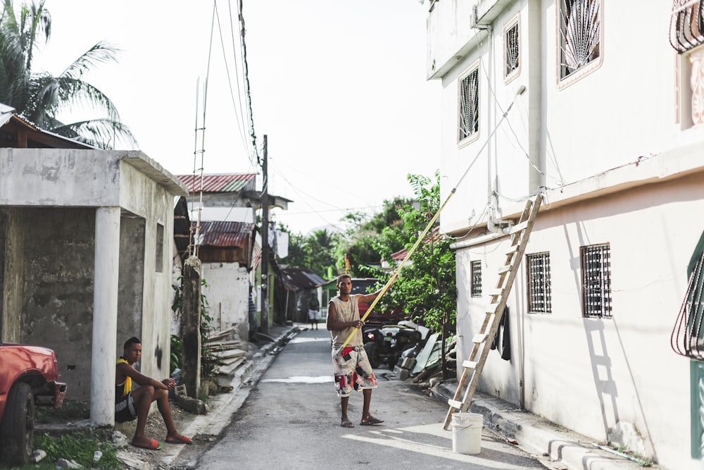 man holding rolling paint brush during daytime