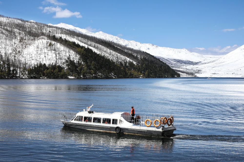 person riding on white motorboat