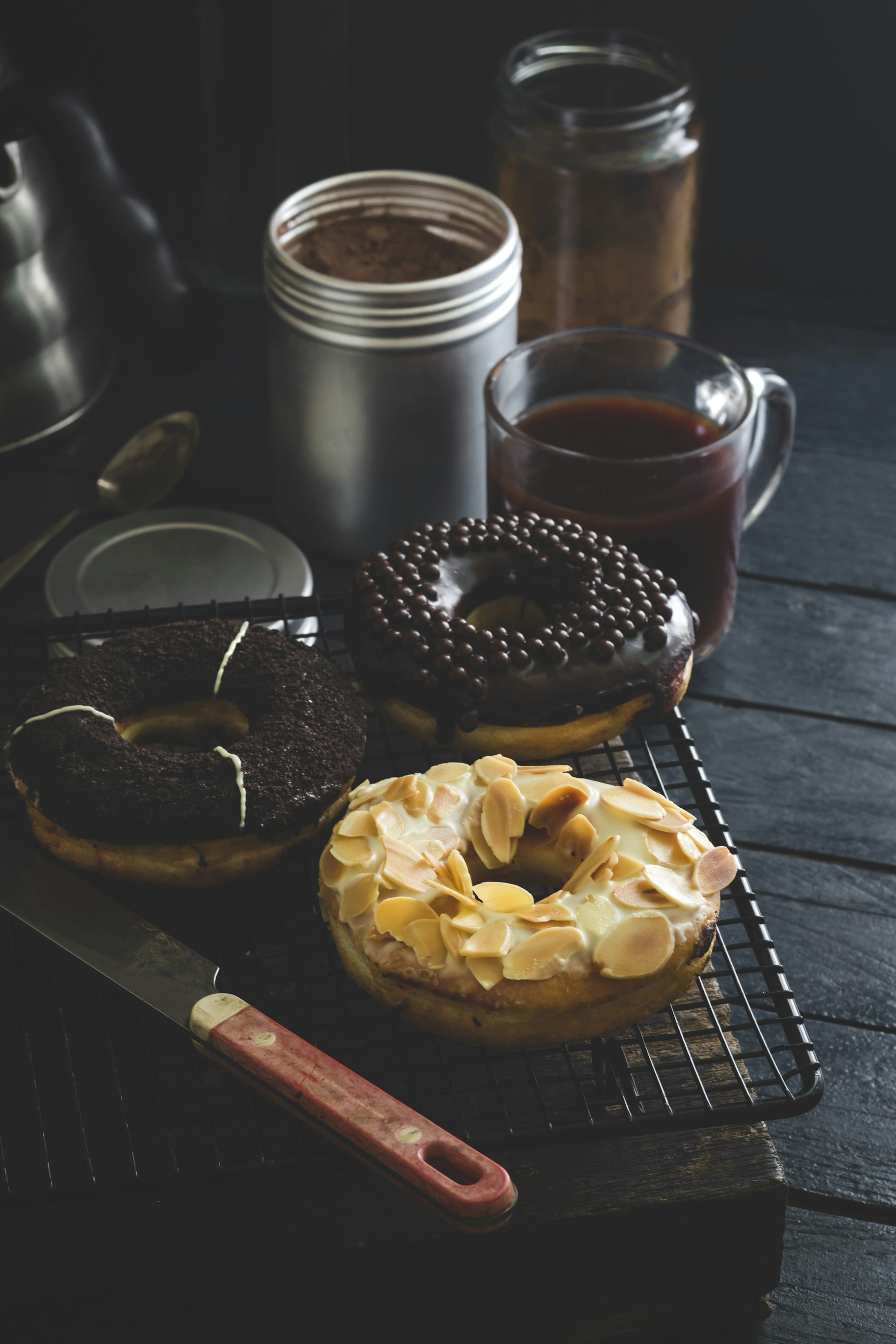 doughnut beside clear glass mug