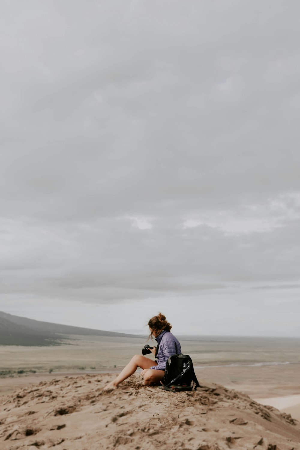 woman sitting on sand