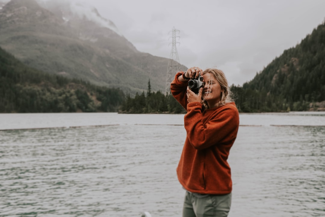 woman taking photo using camera