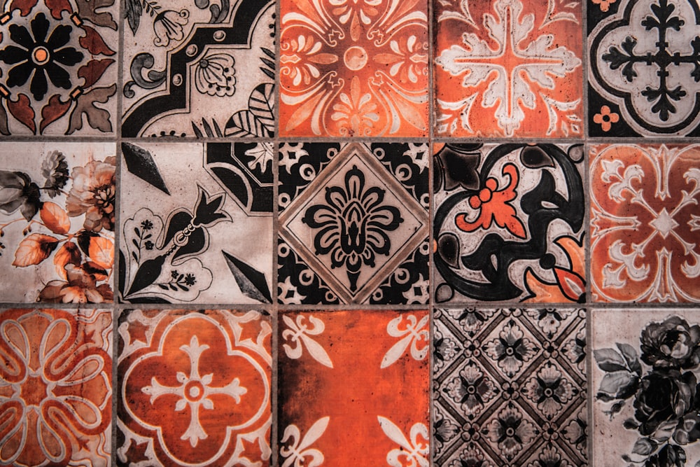 a close up of a tiled wall with different designs