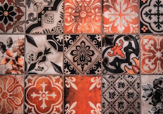a close up of a tiled wall with different designs