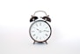 round black and white analog alarm clock