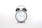 round black and white analog alarm clock