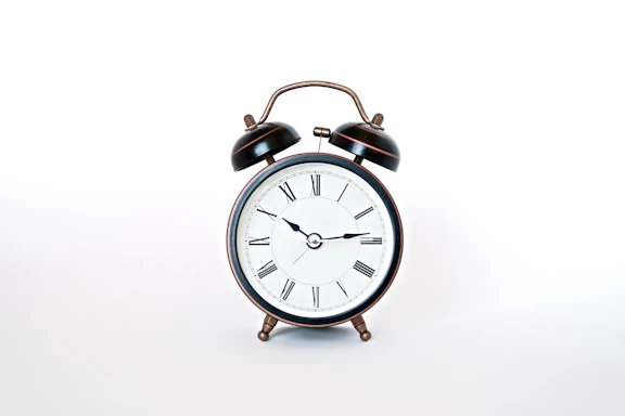round black and white analog alarm clock