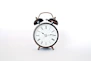 round black and white analog alarm clock