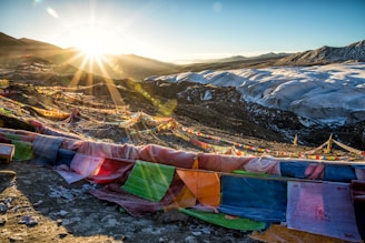 Sunrise over the Himalayan mountains with prayer flags fluttering in the breeze.