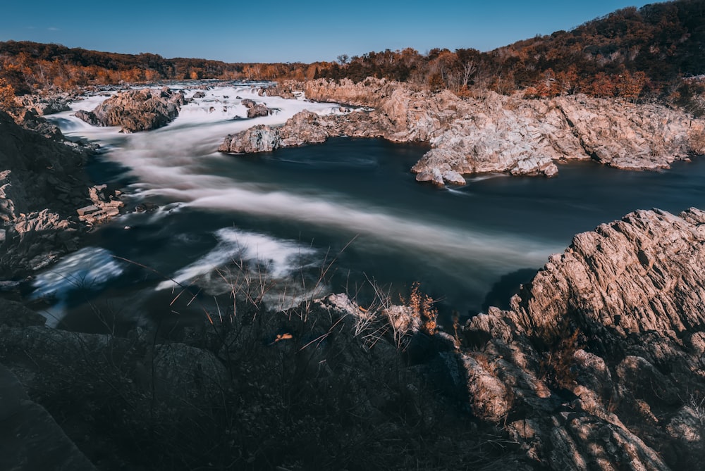 body of water surrounded with mountain