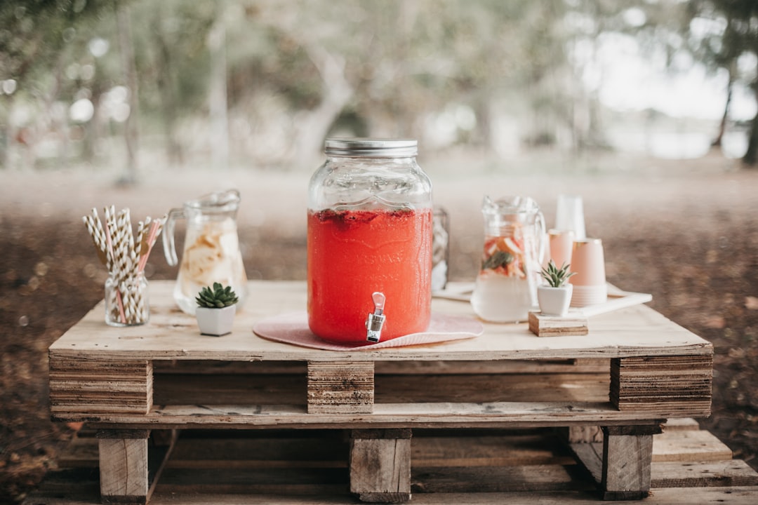  red juice in clear glass jar cold tap