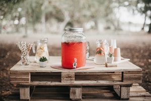 red juice in clear glass jar