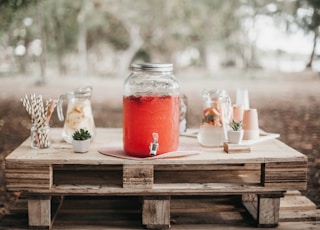 red juice in clear glass jar