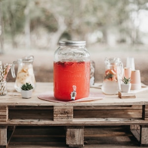 red juice in clear glass jar