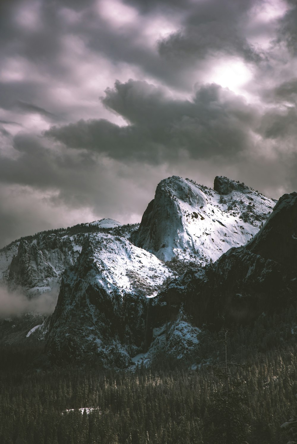 mountain peak under gray clouds