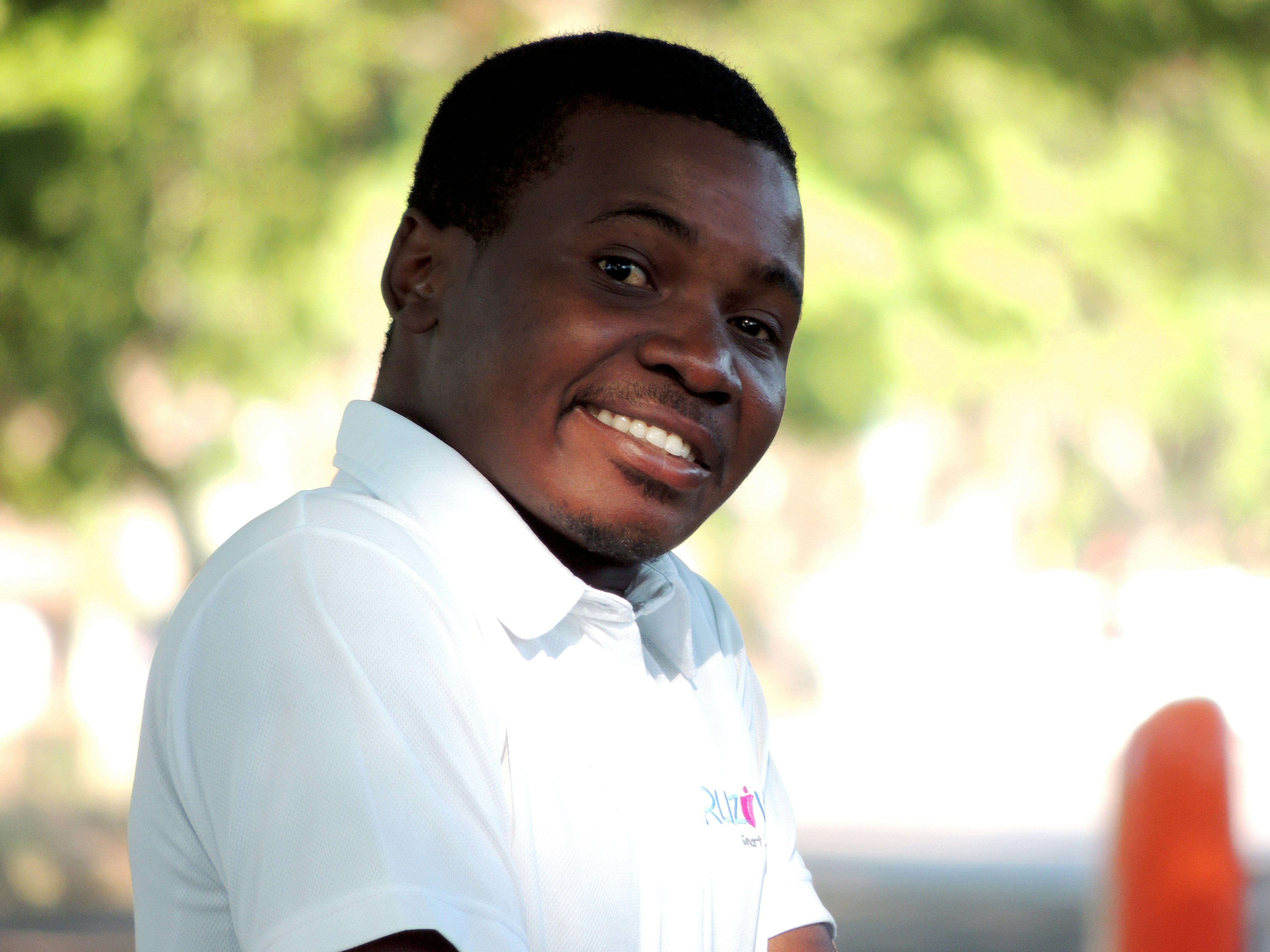 Smiling older White gentleman in polo shirt outdoors in Florida sunshine