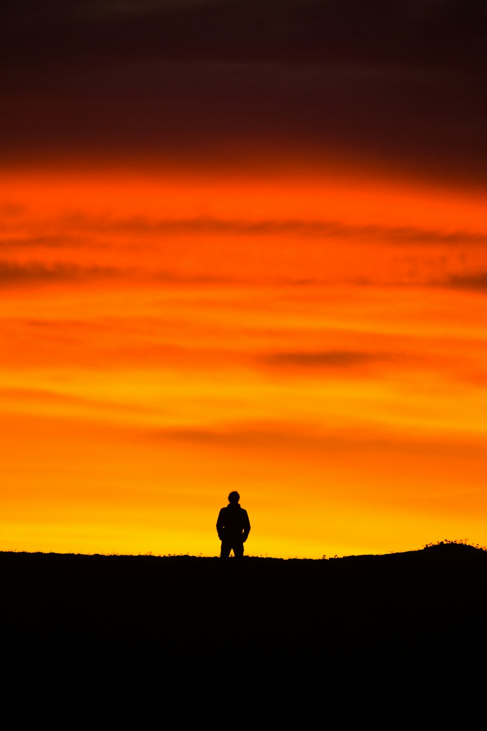man standing at peak at golden hour