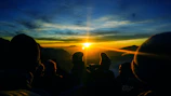 A sunrise over a mountain peak symbolizing new beginnings and hope.